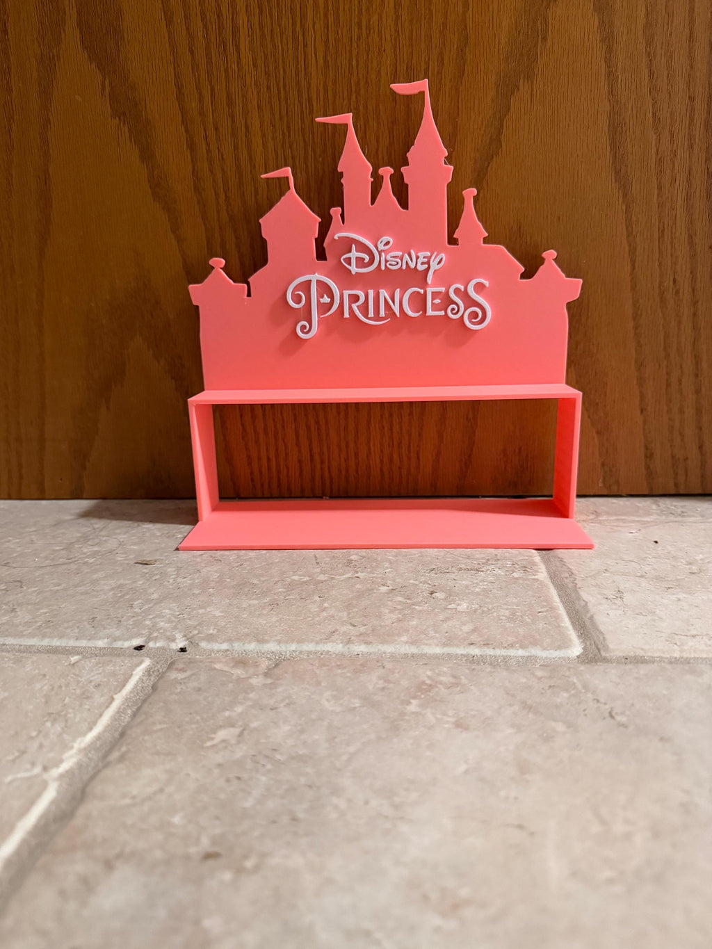 Disney shelf holds mini princesses.