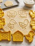 Farm animal cookie cutters in use on cookie dough