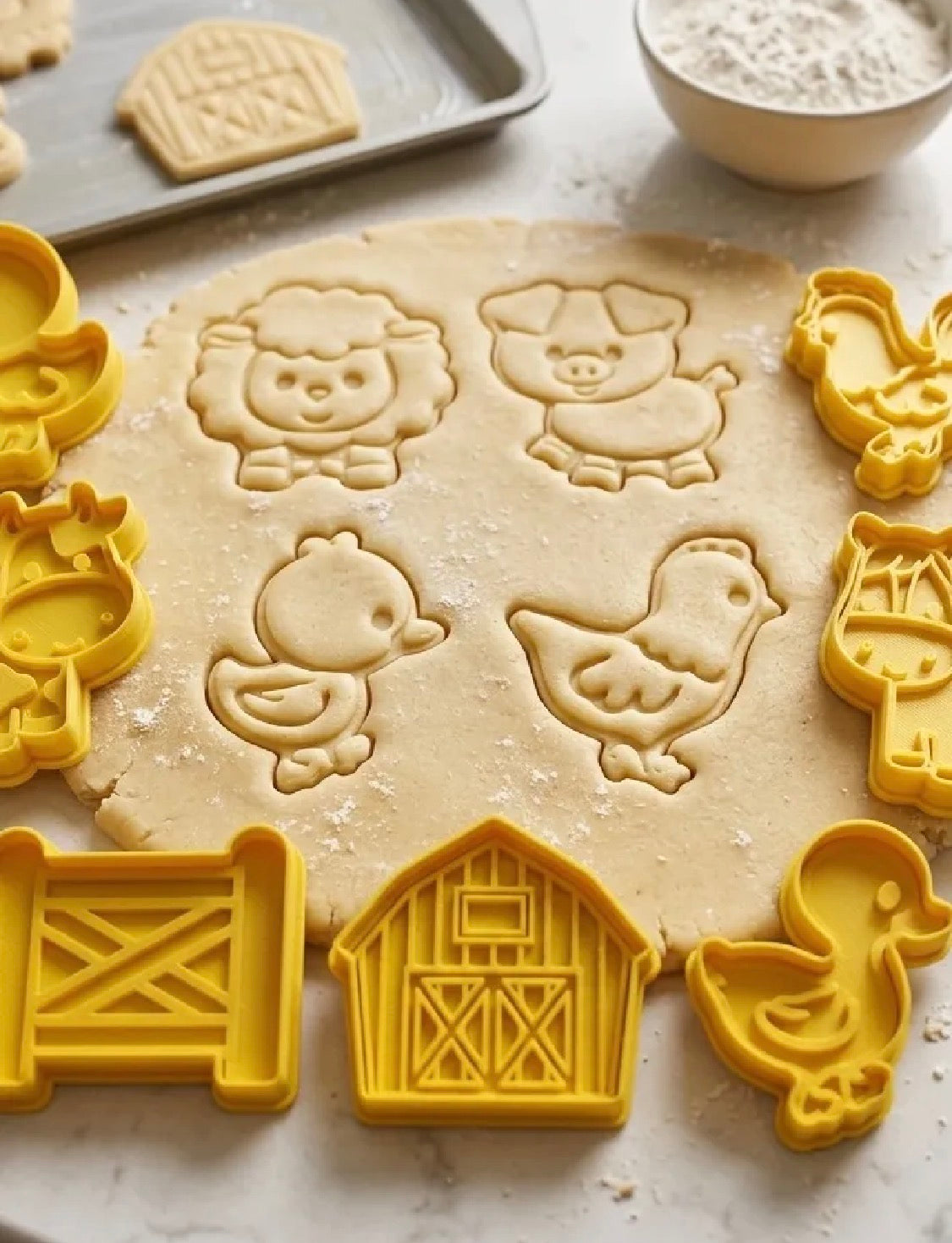 Farm animal cookie cutters in use on cookie dough