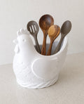 Chicken utensil holder filled with wooden spoons and spatulas