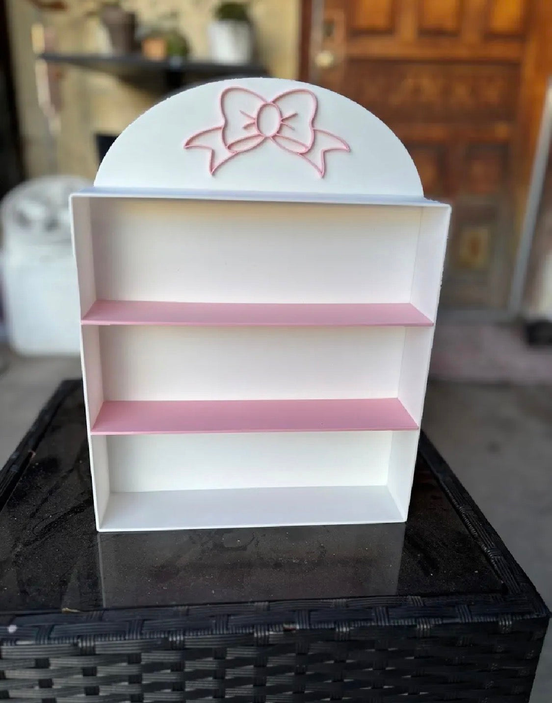 Coquette bow display shelf — side angle view