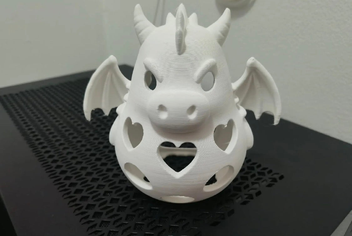 3D printed white dragon night light tealight holder — side angle view fresh off the printer