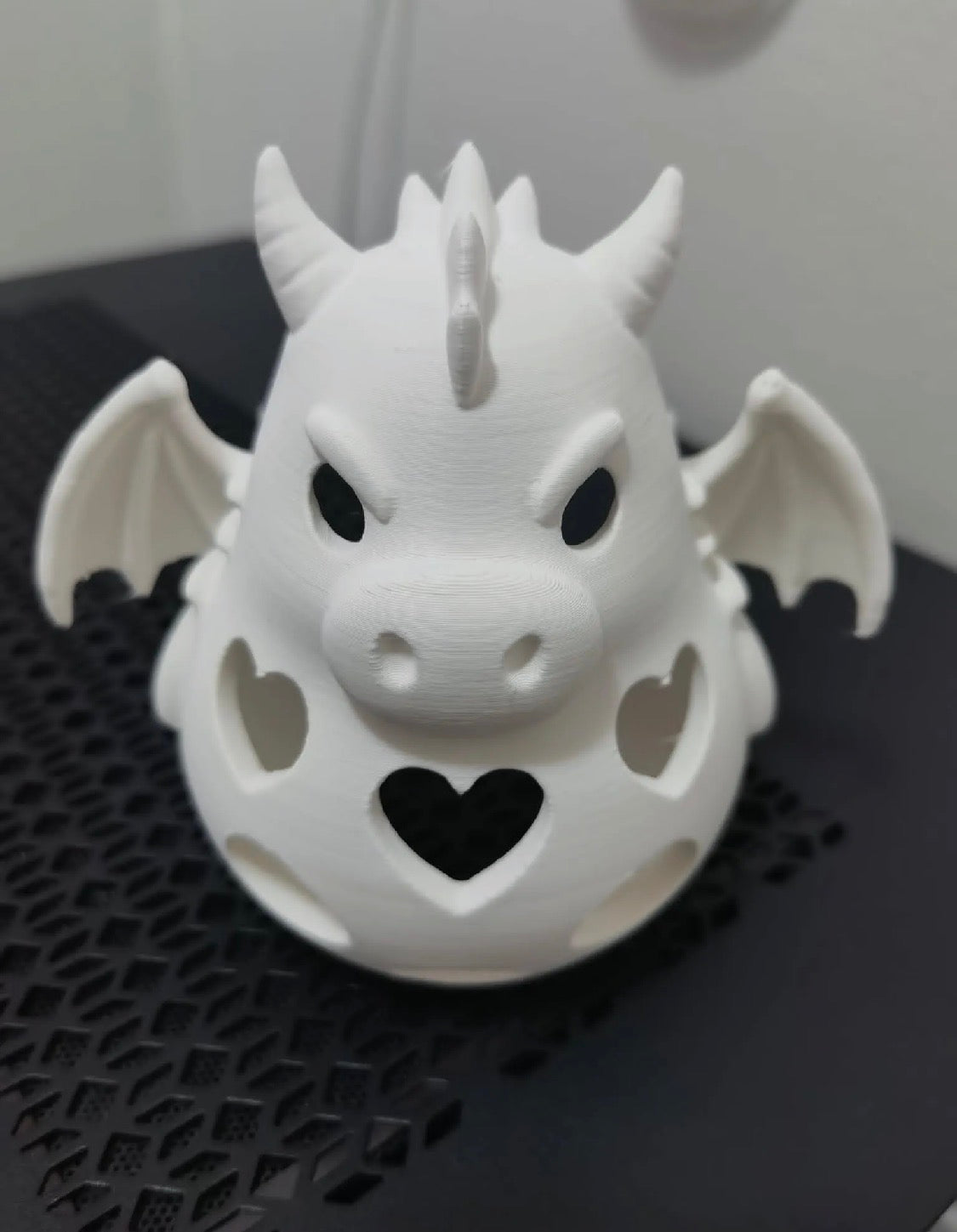 3D printed white dragon night light tealight holder — front face view showing heart cutouts