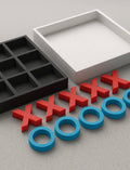 3D printed Tic-Tac-Toe set with red X pieces, blue O rings, and a two-piece storage box