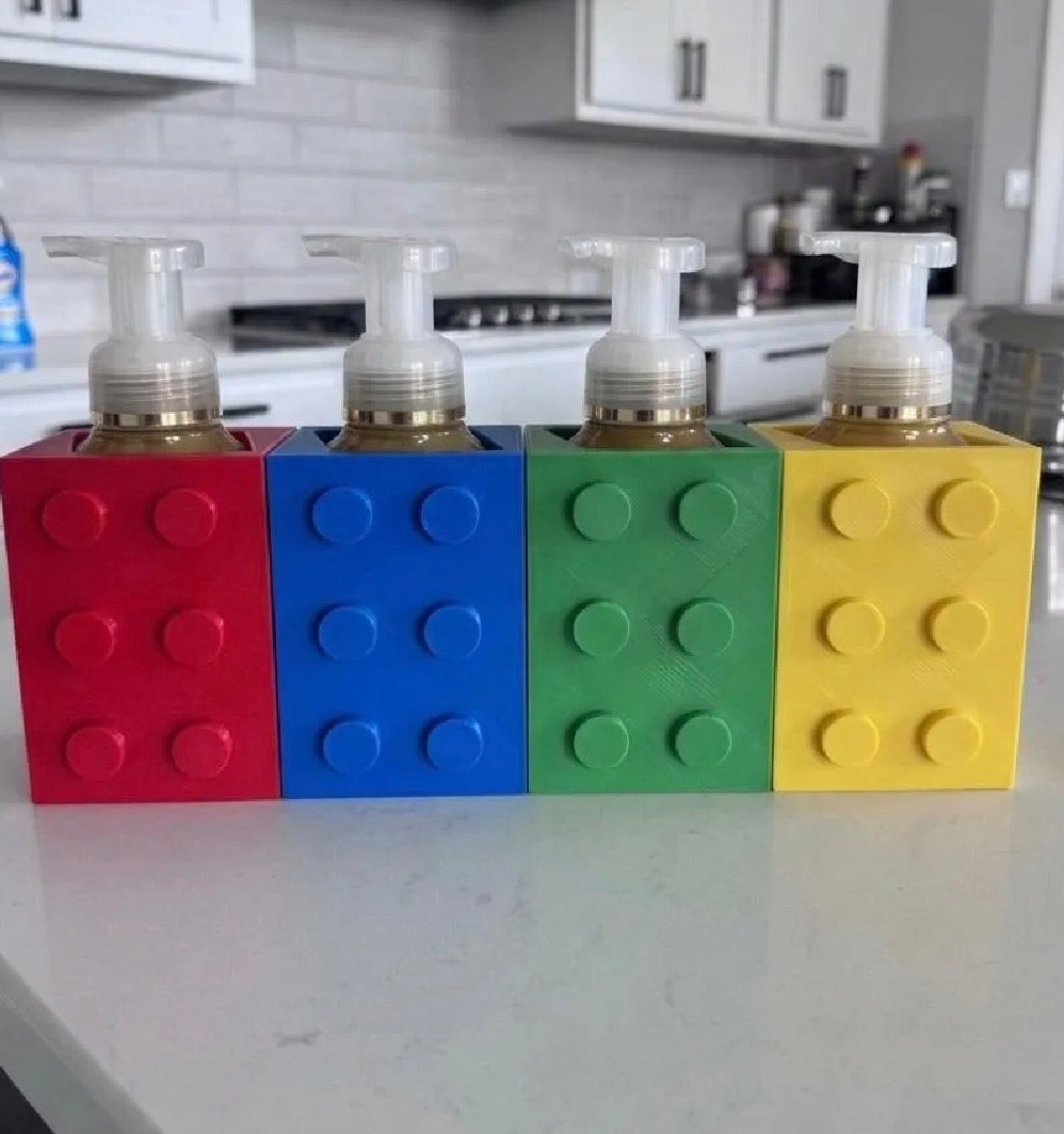 Building block soap dispenser holders displayed at a bathroom sink