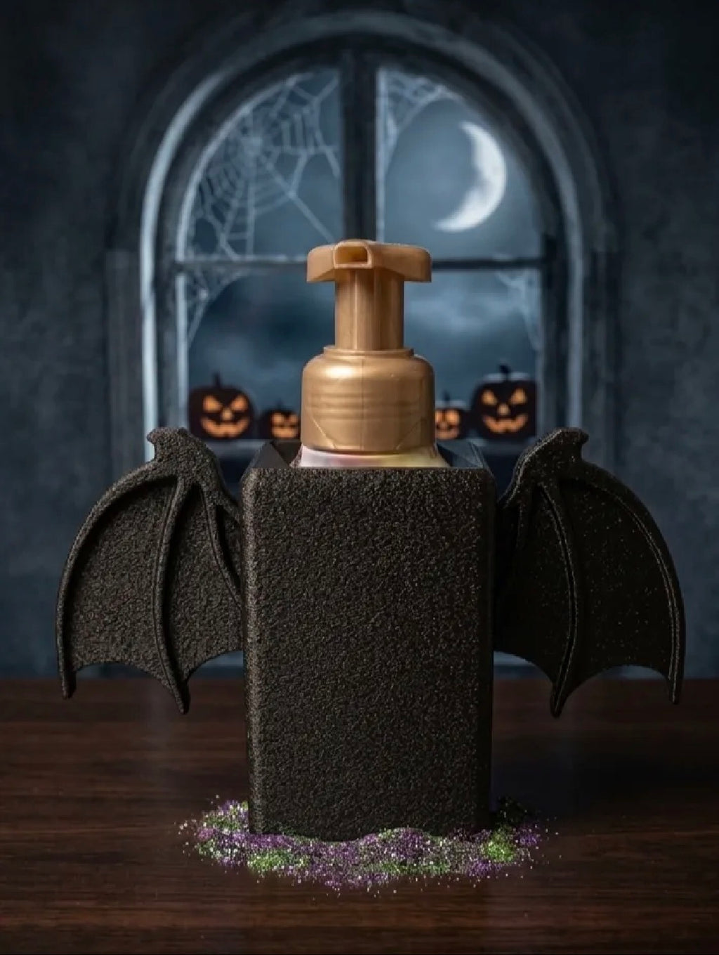 Bat wing soap dispenser holder Halloween lifestyle shot with moonlit window