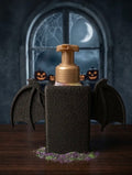 Bat wing soap dispenser holder Halloween lifestyle shot with moonlit window