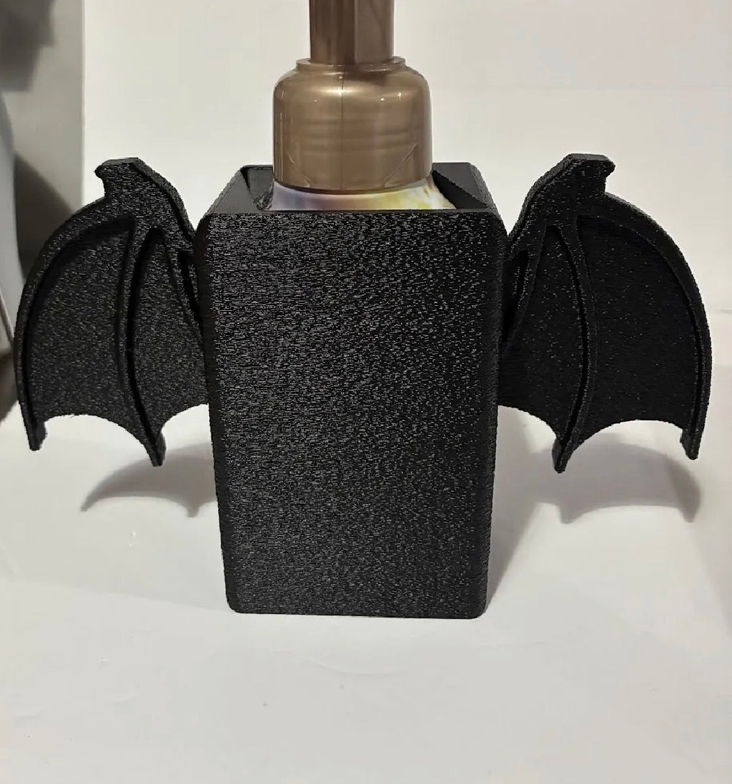 Bat wing soap dispenser holder front view matte black with soap bottle