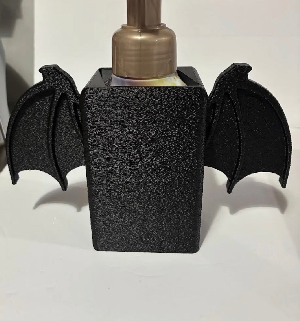 Bat wing soap dispenser holder front view matte black with soap bottle