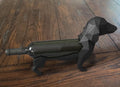 Dachshund wine bottle holder with wine bottle on wooden floor