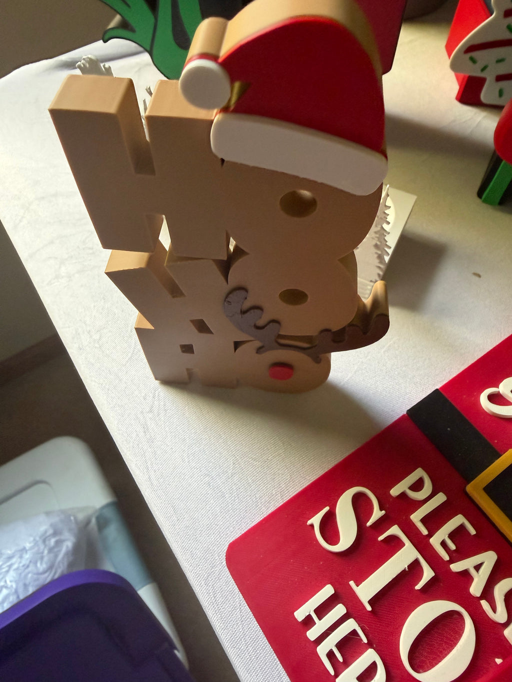 Angled view of stacked Ho Ho Ho Christmas tabletop decoration