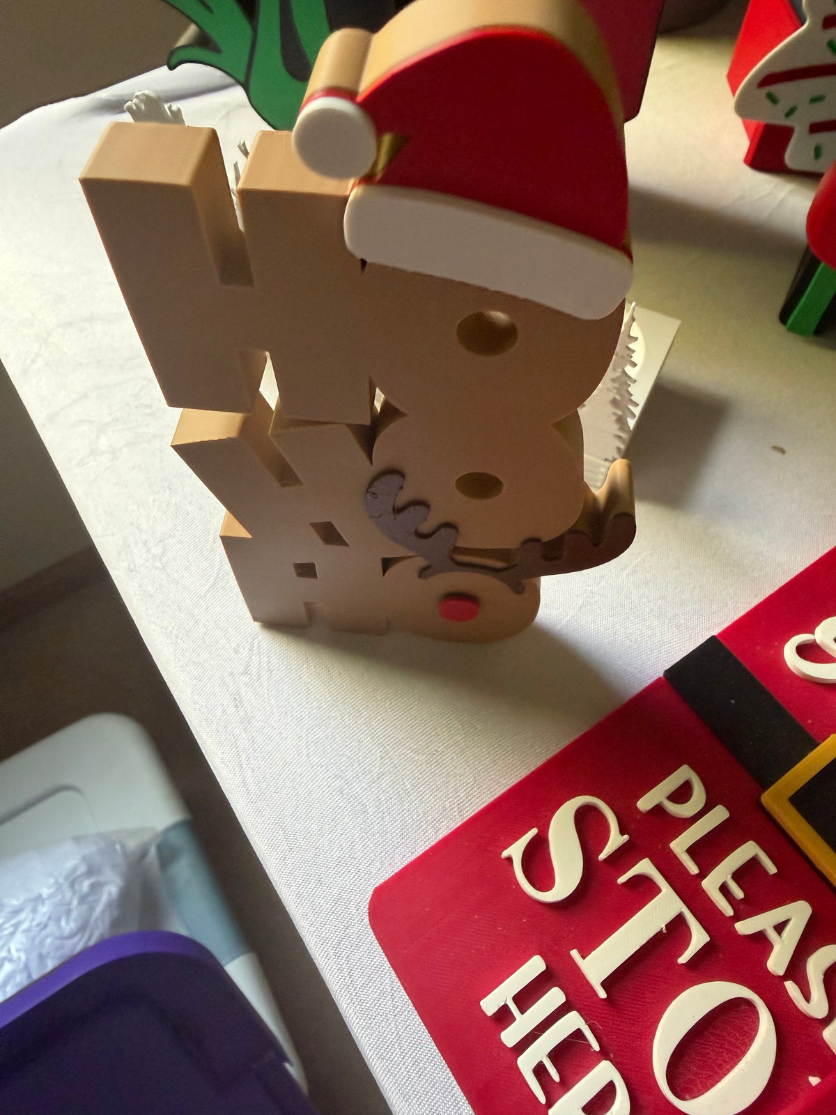 Angled view of stacked Ho Ho Ho Christmas tabletop decoration