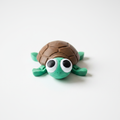 Single baby sea turtle figurine product photo on white background