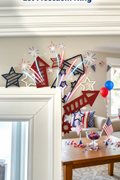 Red white and blue 3D printed firework rocket door frame decorations styled in patriotic 4th of July home setting