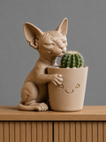 Sphynx cat 3D printed figure hugging a smiling planter with a cactus
