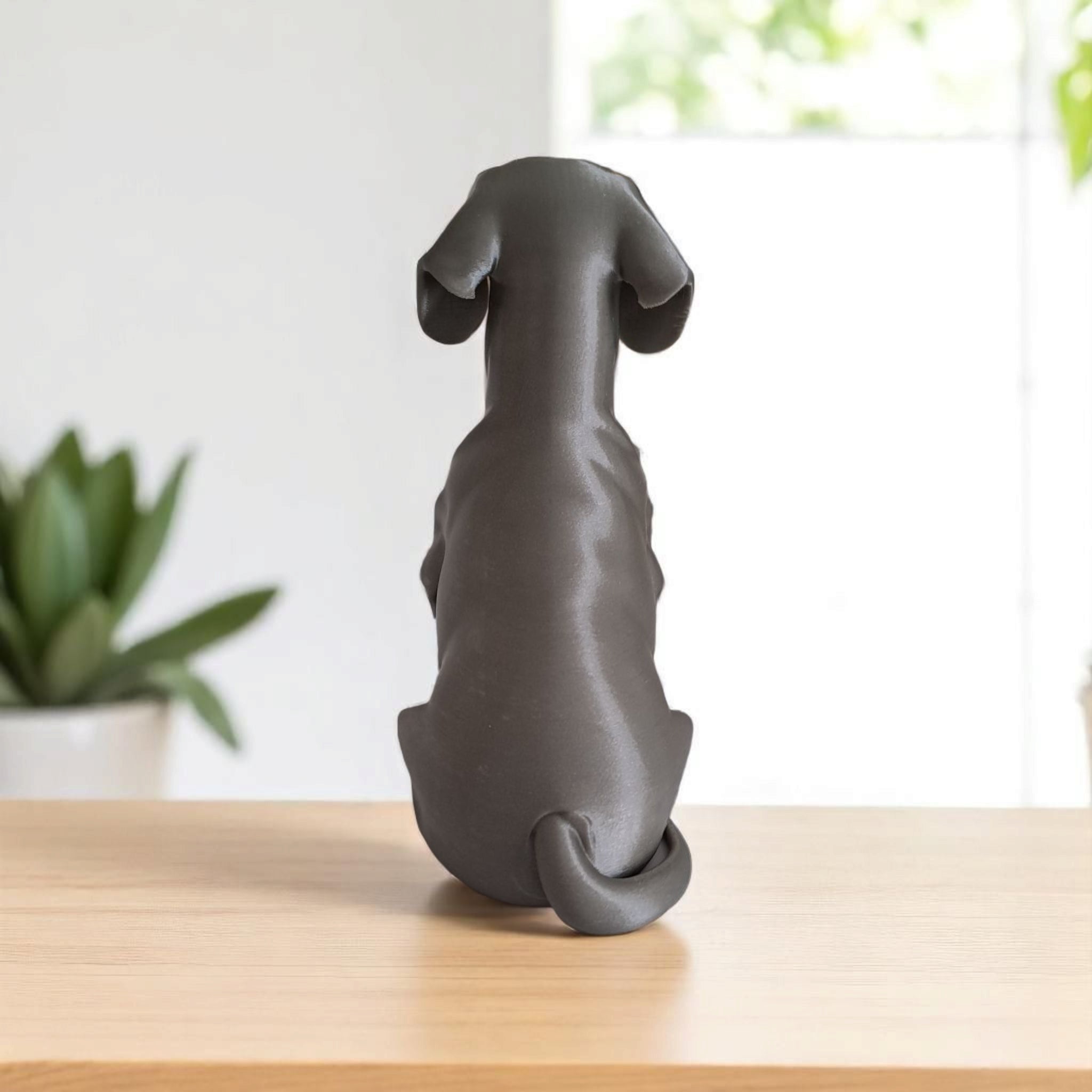 Dachshund dog figurine side view with plant