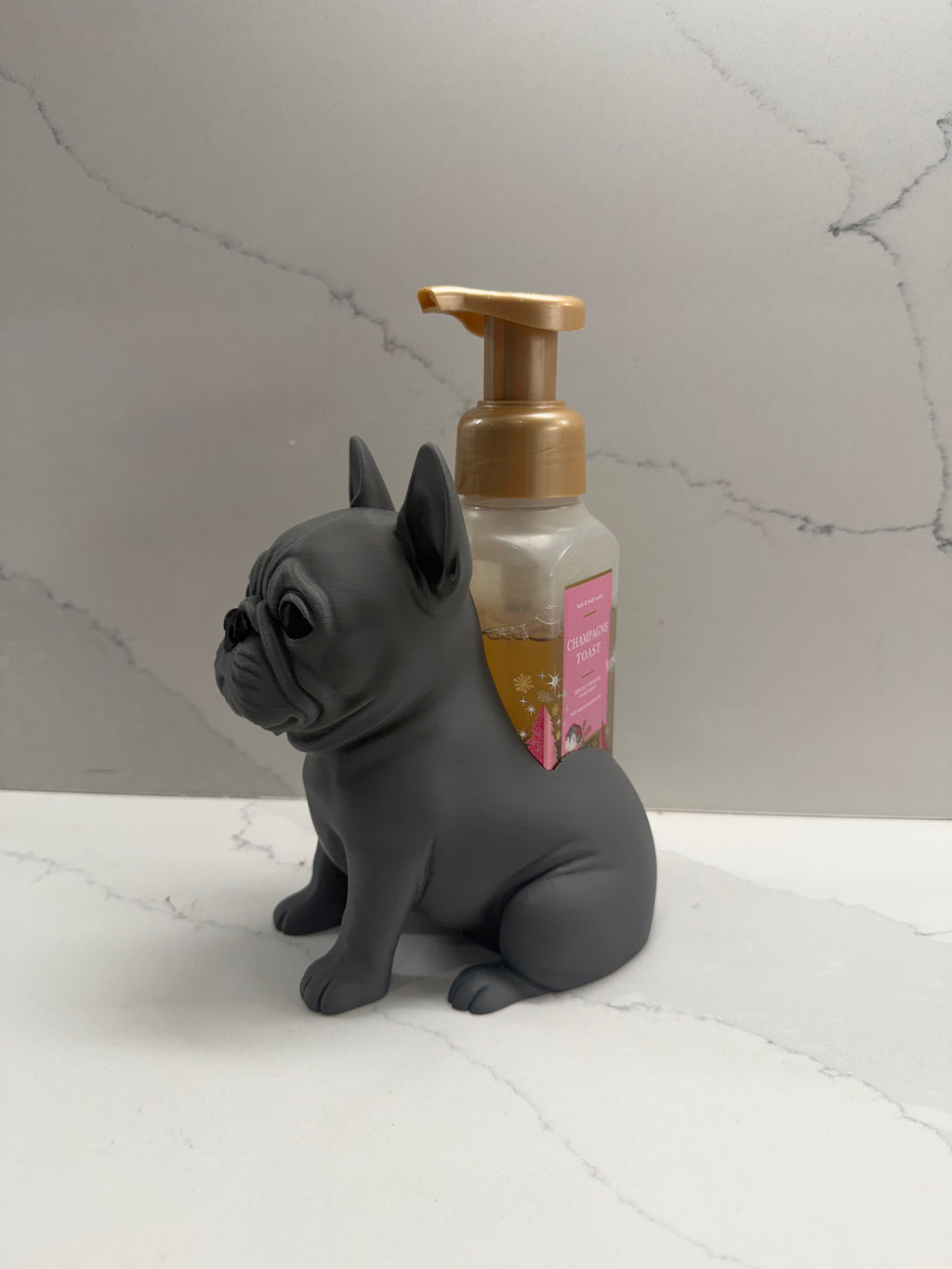 French bulldog soap dispenser holder side angle with branded soap bottle