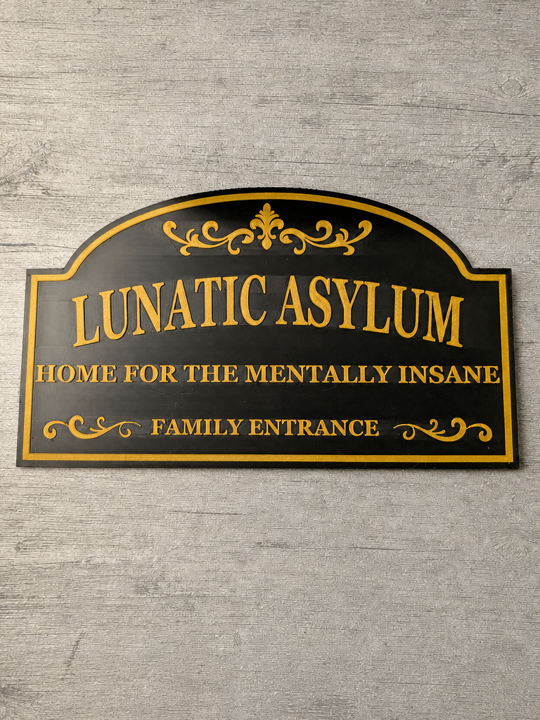 Lunatic Asylum Home for the Mentally Insane Family Entrance sign close-up showing raised gold lettering and scrollwork