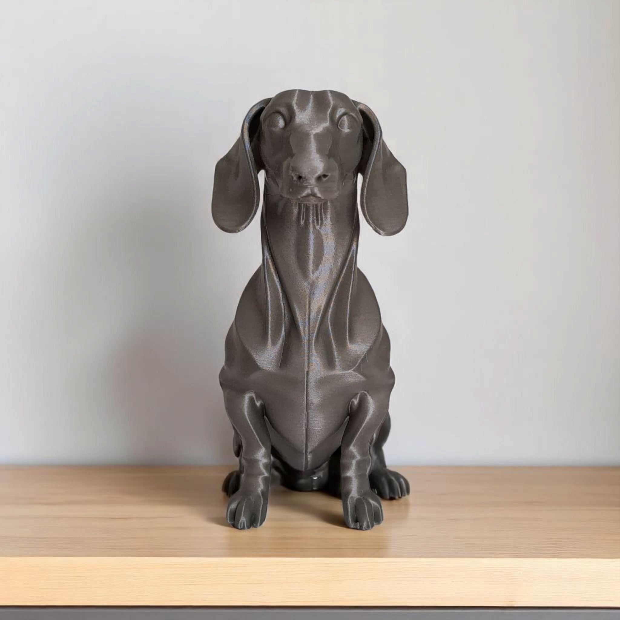 Dachshund dog figurine on bookshelf in warm room