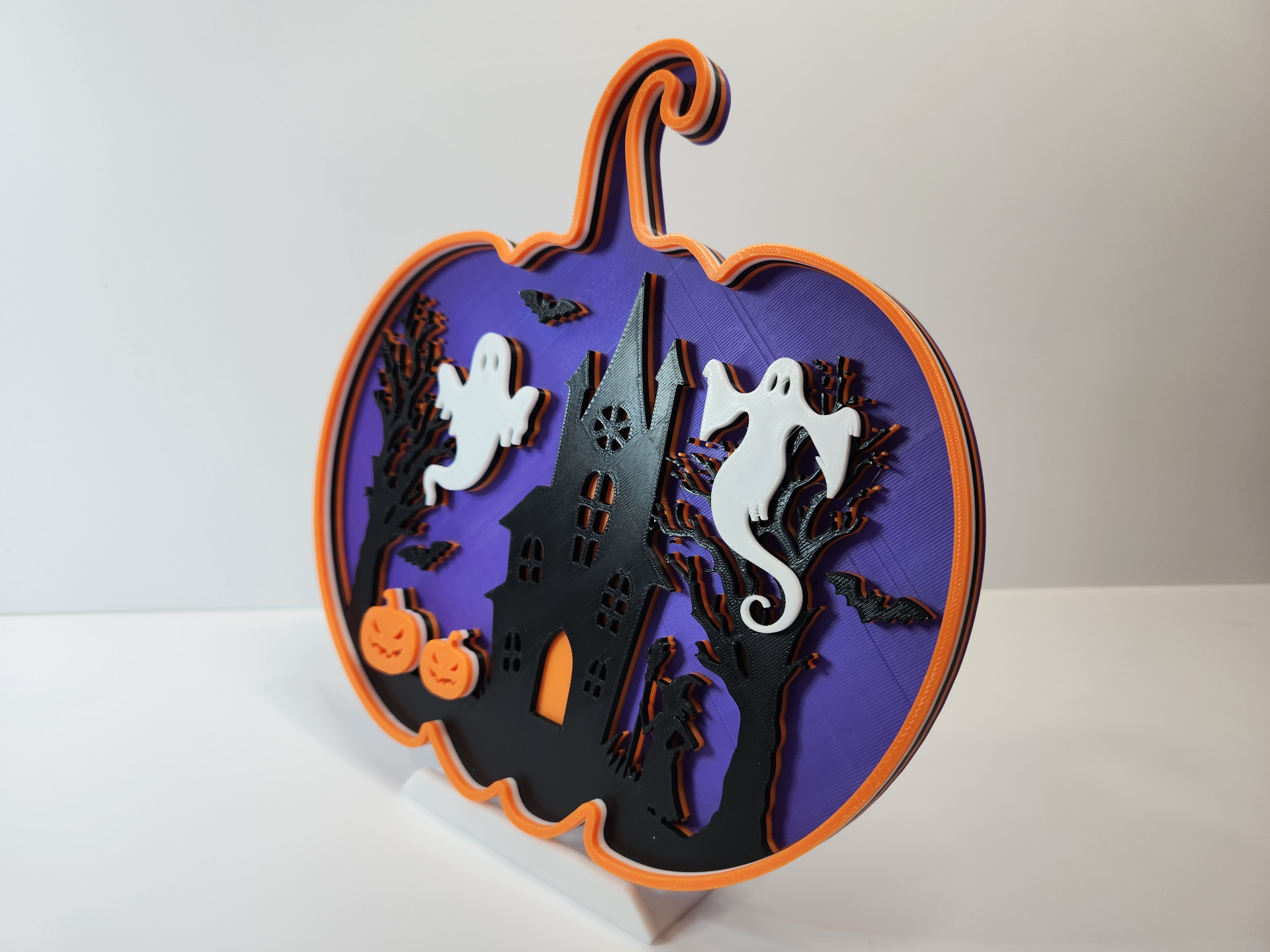 Pumpkin shadow box Halloween wall decor displayed on a brick wall showing hanging option