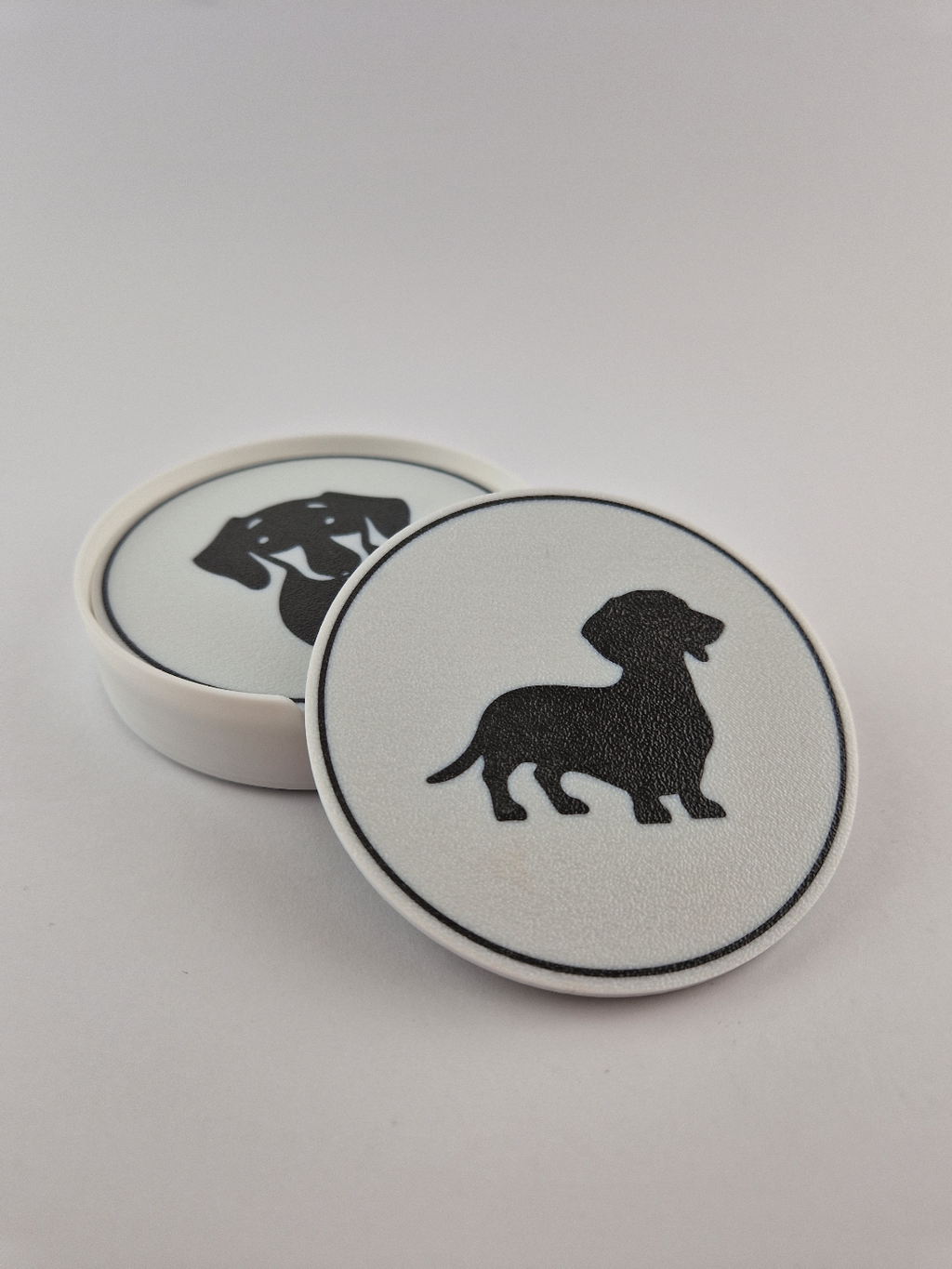 Two dachshund coasters stacked showing standing pose detail