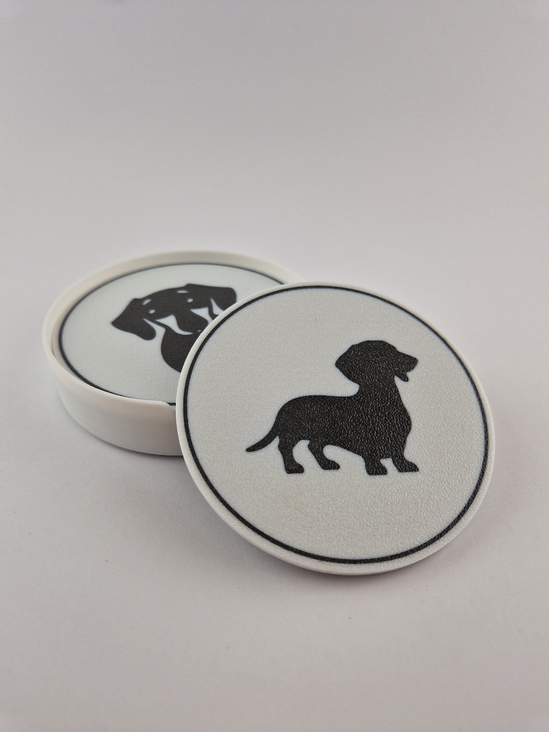 Two dachshund coasters stacked showing standing pose detail