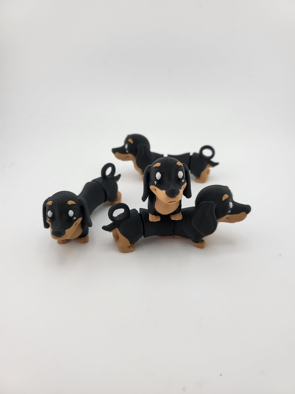 Multiple flexi dachshund keychains arranged together