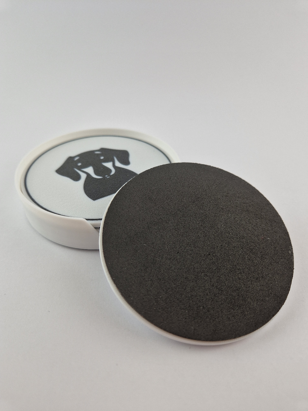 Dachshund coaster showing cork backing and holder