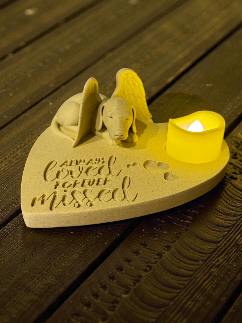 Dachshund angel memorial candle holder with tea light glowing on wooden surface