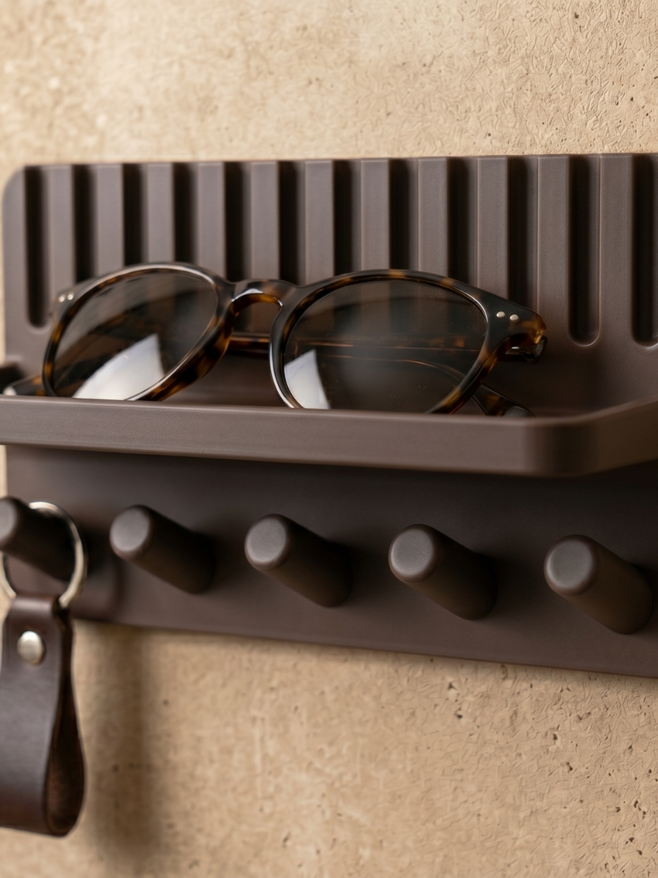 Close-up of key holder shelf showing ribbed texture and sunglasses detail