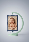 Spinning photo frame stand with baby photo on light background