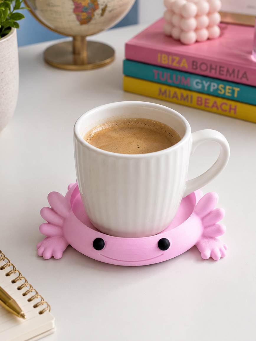 Pink 3D printed Axolotl coaster on wooden surface