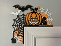 Multi-layer 3D printed Halloween door corner decoration with jack-o-lantern, spider webs, bats, and fall leaves in orange, black, and white